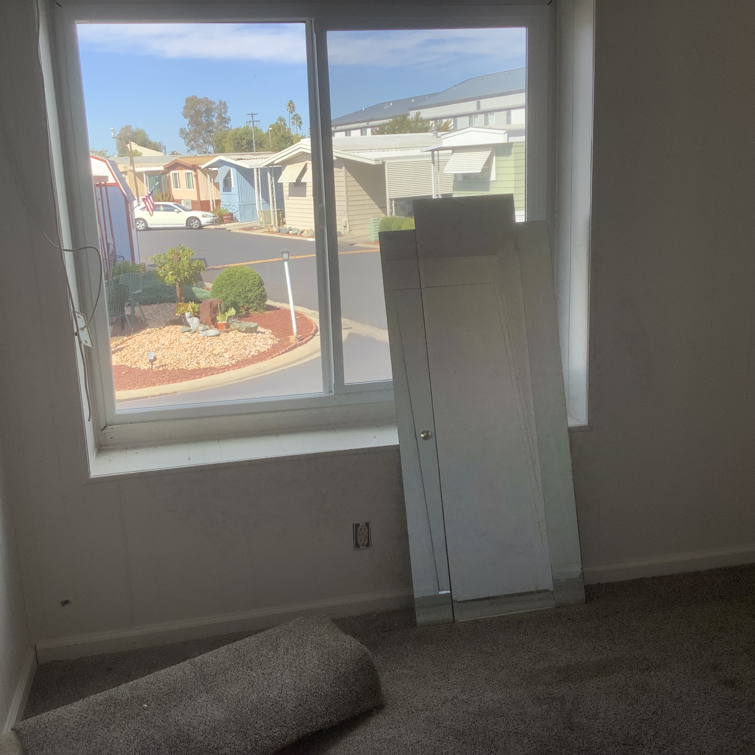 Interior window looking toward neighboring homes in the park