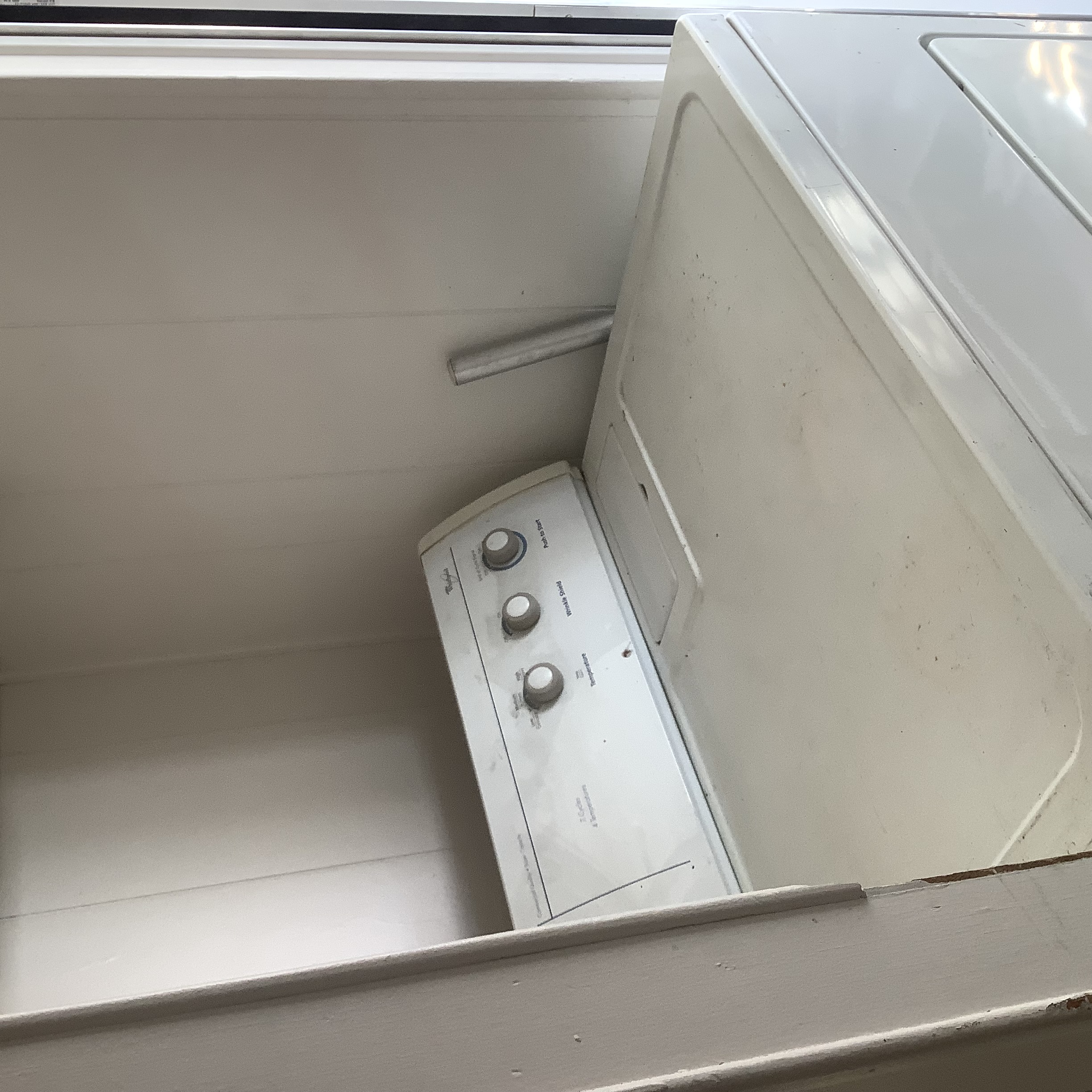 White laundry appliance in the laundry area